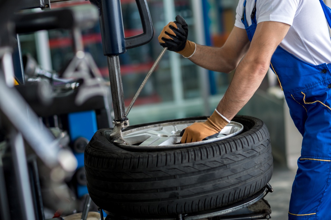 engineer balancing car wheel on balancer